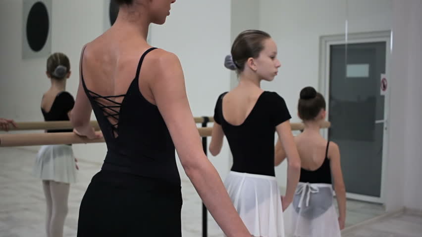 Teacher, proffesional ballerina, teaches her heirs arm positions or smooth moves