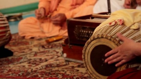 Krishna plays on Indian spiritual instruments