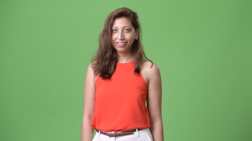 Beautiful businesswoman against green background
