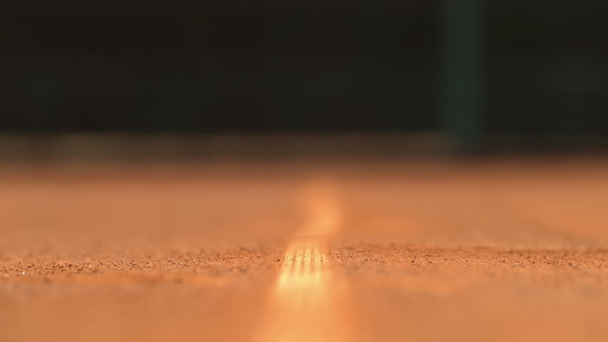 Tennis ball hitting the ground and leaving dust | Shutterstock HD Video #1011186698