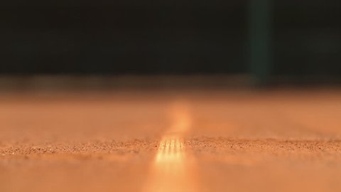 Tennis ball hitting the ground and leaving dust