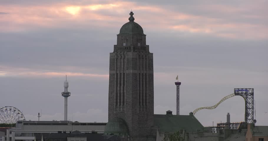 4K high quality video of beautiful cloudy rain approaching scenic colourful sunset over Helsinki downtown in summer with cathedral silhouette view and city skyline of Finnish capital, northern Europe