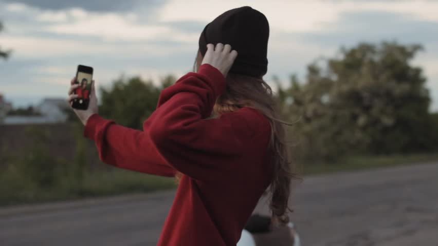 Girl in red sweater make selfie on phone outdoor | Shutterstock HD Video #1011195083