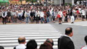 Blurred video of people walking the Shibuya crossing, probably the busiest pedestrian crossing in the world, Tokyo, Japan