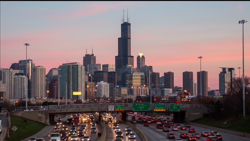 Chicago Skyline Over a Busy Highway Between Day and Night