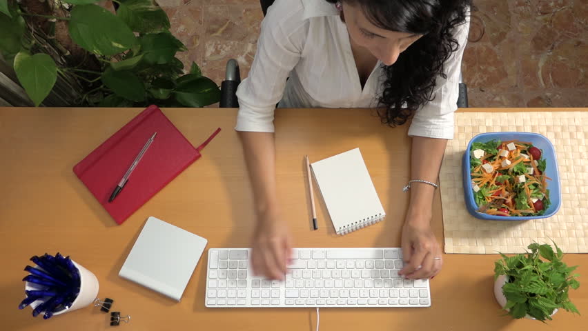 Active businesswoman working at office and having meal, stressful lifestyle. Busy caucasian woman typing on the keyboard and eating salad simultaneously without lunch break, no time, working hard Royalty-Free Stock Footage #1011197654