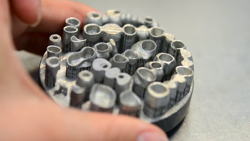 Object printed on metal 3d printer. Dental crowns created in a laser sintering machine close-up. DMLS, SLM, SLS technology. Concept of 4.0 industrial revolution. Progressive modern additive technology