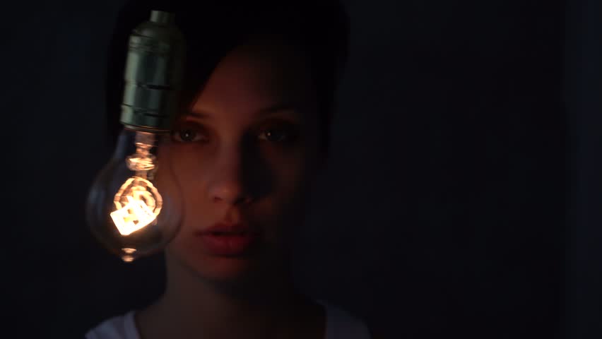 Beautiful mystical girl with a light bulb