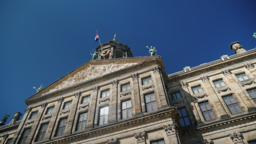 The Royal Palace in Amsterdam is the former Amsterdam Town Hall. The sun shines beautifully in the windows. The building was built in 1665 by Jacob van Kampen