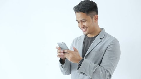 portrait of young asian business man looking at smartphone