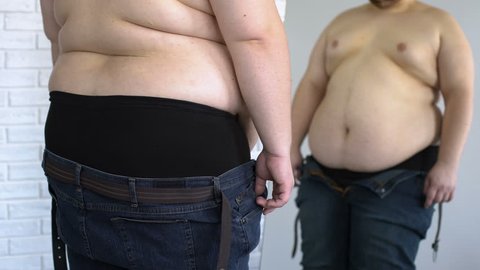 Fat Man Trying Put On Pants Stock Photo 631901717