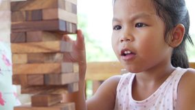 Happiness asian girl and friends having fun playing build block together. Recorded video in 60 fps