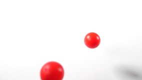 bouncing balls popping and rolling onto around on a white background, red ping-pong plastic fun ball movement. - Powered by Shutterstock - Get 15% off with code: PIKWIZARD15