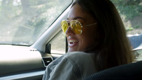 Happy Woman Dances And Sings To Her Friend (The Driver) On A California Road Trip