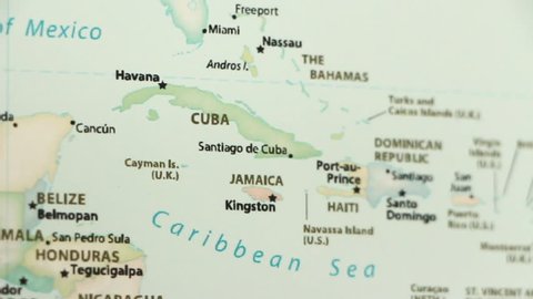 Cuba and Jamaica on a political map of the world. Video defocuses showing and hiding the map.