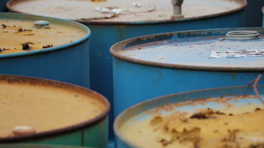 Old rusty barrels with oil products casks