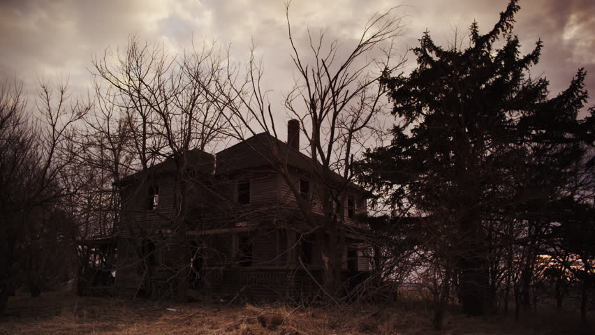 Haunting abandoned Victorian farm house surrounded by unkept trees under a dreary autumn sky Royalty-Free Stock Footage #1011263378