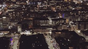 Aerial pan, city streets at night