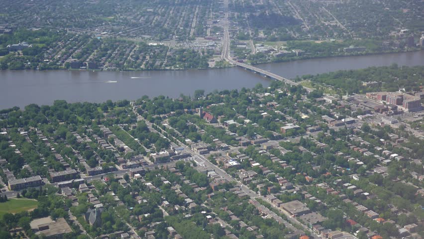 Airplane window view of Ontario Toronto Canada with residential houses, river and on going traffic seen