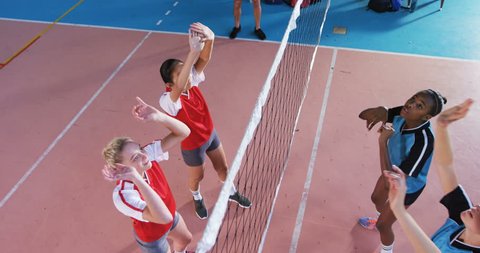High angle view of diverse female volleyball players playing volleyball in the court 4k