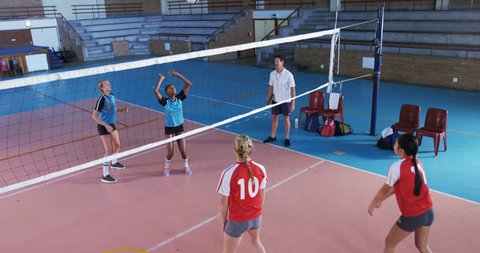 Woman volleyball players playing volleyball in the court