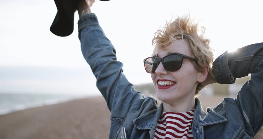 Carefree millennial on a beach in evening light