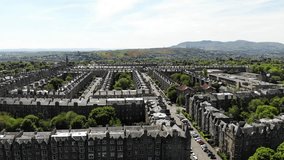 Aerial drone footage of suburban houses and fields in Edinburgh, Scotland, UK 
