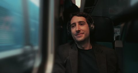 Passenger listening to music while riding train