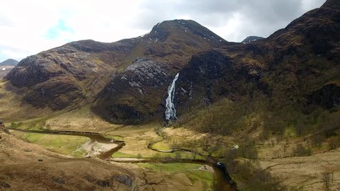 4K Drone shot of Steall waterfall valley in  Scottish Highlands. Moving image of Scotland UK sun light and clouds over summer mountains inGlen Nevis blue sky landscape