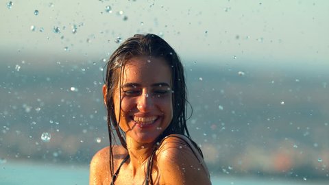 Water drops falling on a young woman's face