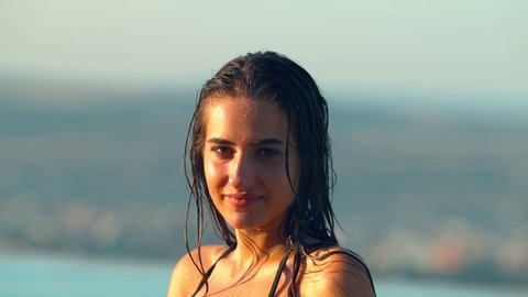 Water splashing on a young woman's face