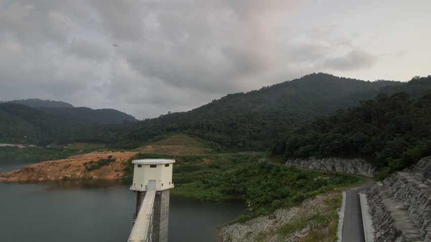Timelapse high angle aerial view the Mengkuang Dam at Bukit Mertajam. Nature with forest nearby.
