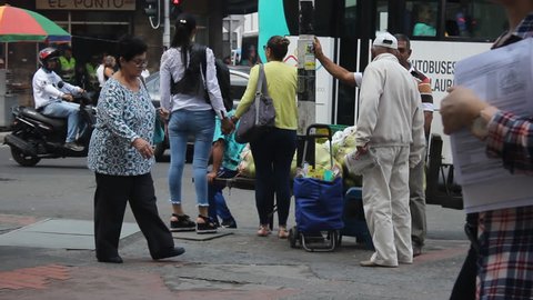 Medellin, Colombia - May 1, 2018: People and traffic in a Medellin dangerous downtown street