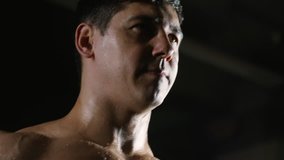 Tilt down of muscular shirtless bodybuilder with sweaty torso doing dumbbell curls - Powered by Shutterstock - Get 15% off with code: PIKWIZARD15