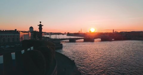 Aerial view of sunset over Neva river and Rostral columns in Saint Petersburg, Russia. Vasilievskiy island city from above, cinematic drone video, historical buildings of nothern capital