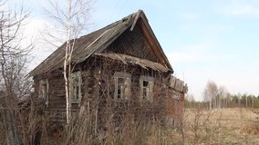 Old Russian village abandoned house on an abandoned field.