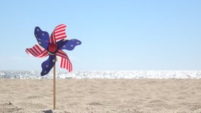 July 4th spinner with stars and stripes on the beach