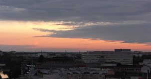4K high quality video of beautiful cloudy rain approaching scenic colourful sunset over Helsinki downtown in summer with cathedral silhouette view and city skyline of Finnish capital, northern Europe