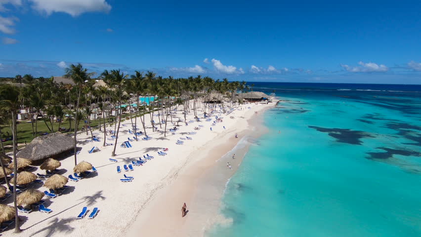 The best beaches in world. Top view of the beach of the Bahamas/Hotel on shore of blue sea. Dominican Republic, Punta Cana. White sand, beautiful beach, tall palm trees. Turquoise sea water vacation 