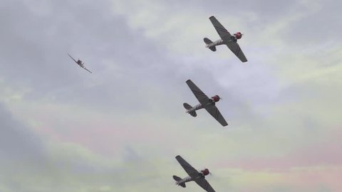 Squadron of World War II P51 military fighter bomber airplanes flying in slow motion 