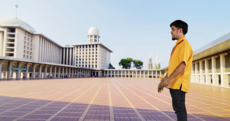 Happy muslim father hugging his son in Istiqlal Mosque at Jakarta, shot in 4k resolution during Ramadan Kareem