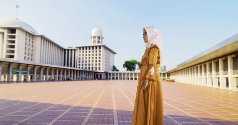 Happy young muslim mother hugging her son in Istiqlal Mosque at Jakarta, Indonesia. Shot in 4k resolution