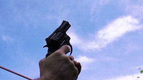 Man shoots with a pistol to the sky to signal the start. Slow-motion shooting of 960 frames per second.