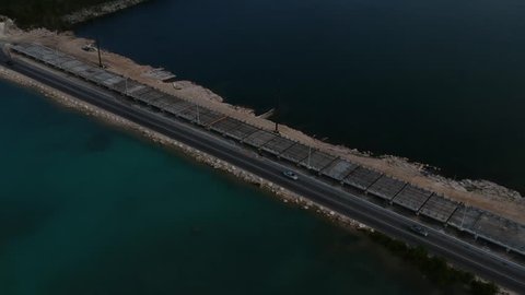 Low aerial view of construction of new Fishing hole road bridge in Freeport, Grand Bahamas with traffic on the old road