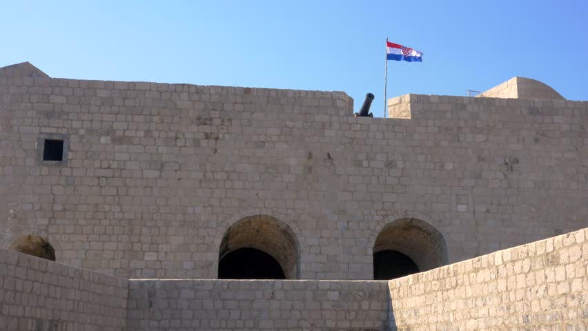 A wide shot of a cannon on the walls of Dubrovnik