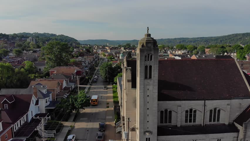 A slowly lowering morning aerial establishing shot of a small town