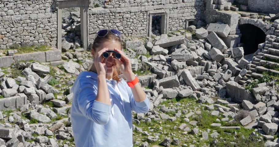 Young woman in amphitheater in Pisidian city Thermessos built at an altitude of more than 1000 metres near Antalya in Turkey.