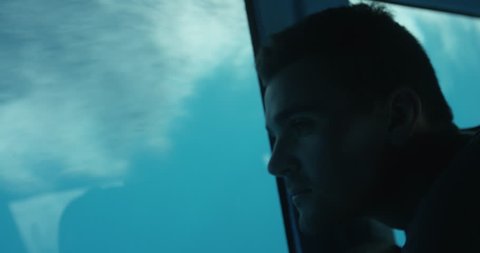 Close-up on a Man Looking at the Underwater Life while Being on the Boat with the Glass Bottom. Shot on RED Epic 4K UHD Camera.