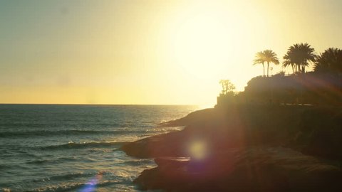 Ocean and Beautiful Rocky Shore in the Sunset. Idyllic Exotics Island with Palm Trees and Promenade. Shot on RED Epic 4K UHD Camera.