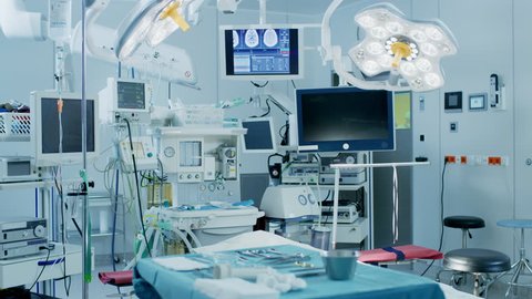 Establishing Shot of Technologically Advanced Operating Room with No People, Ready for Surgery. Real Modern Operating Theater With Working Equipment. Shot on RED EPIC-W 8K Helium Cinema Camera.